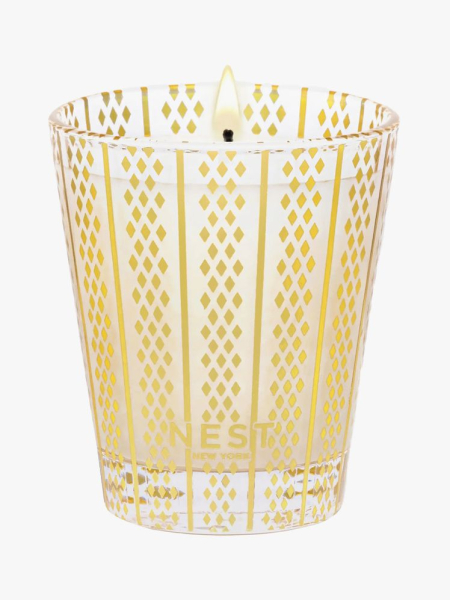 Nest Holiday Candle in branded component on a light gray background